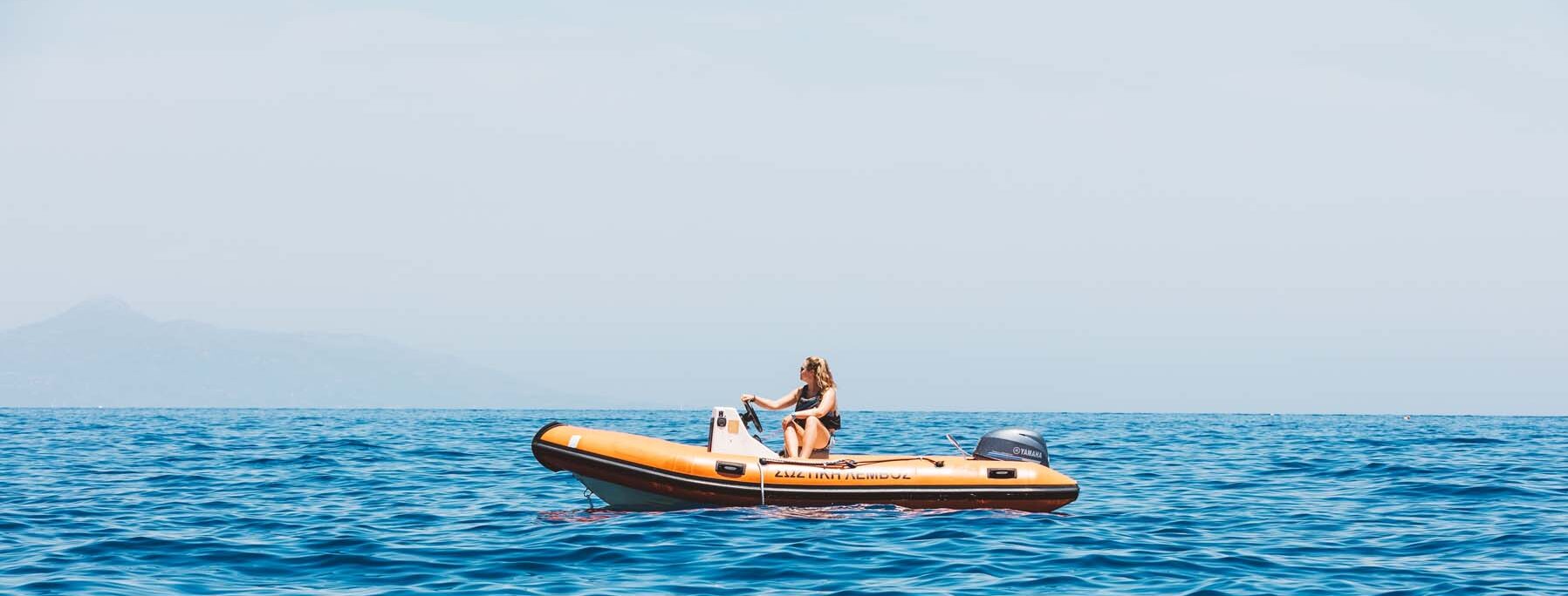 A watersports instructor in an orange powerboat