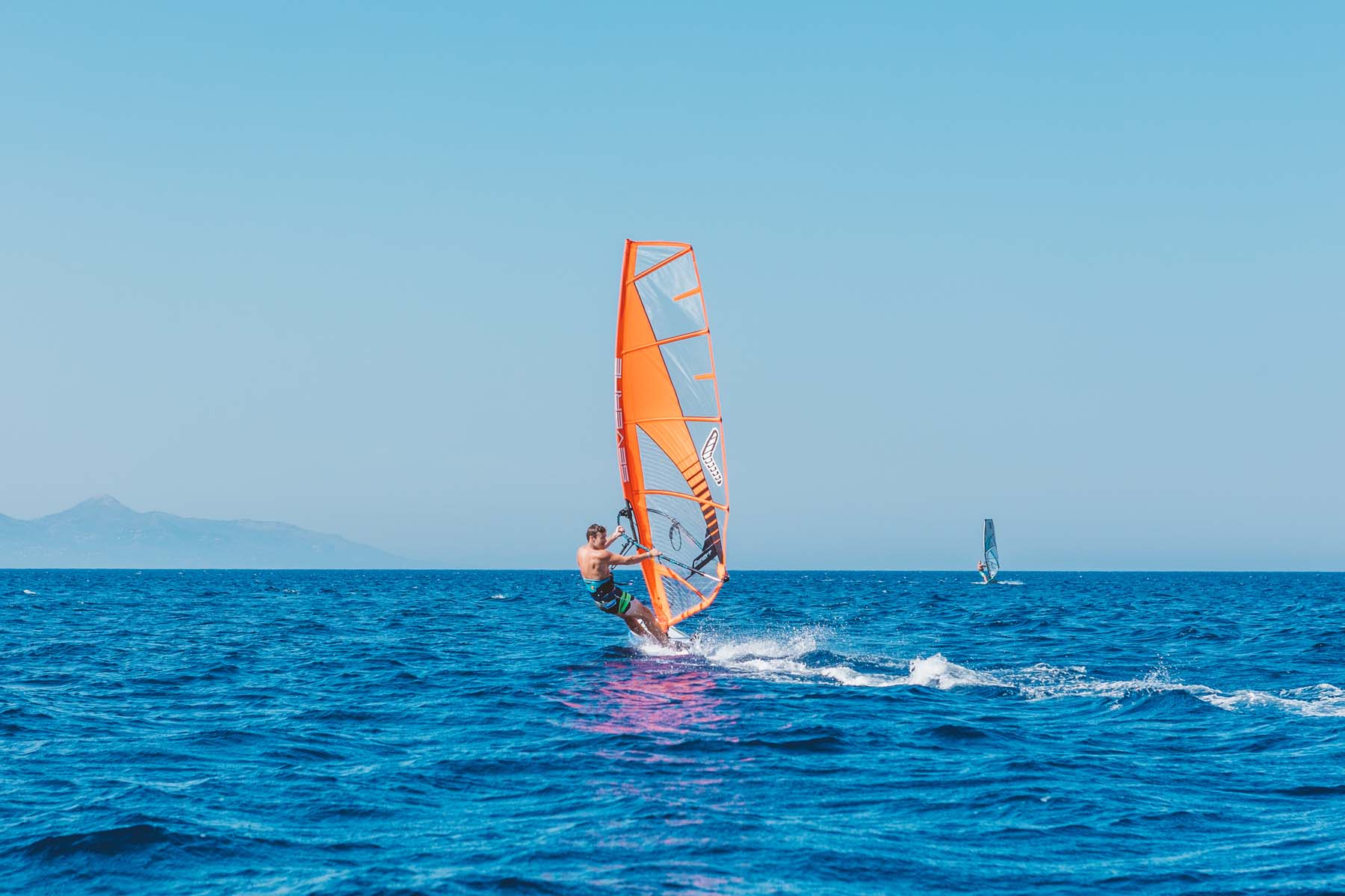 Peligoni Club guests windsurfing on the Ionian Sea