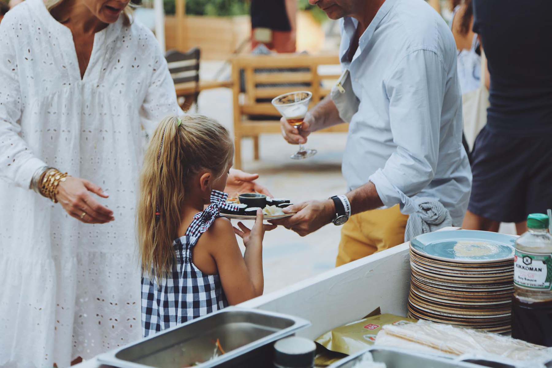 A young girl with a plate of sushi