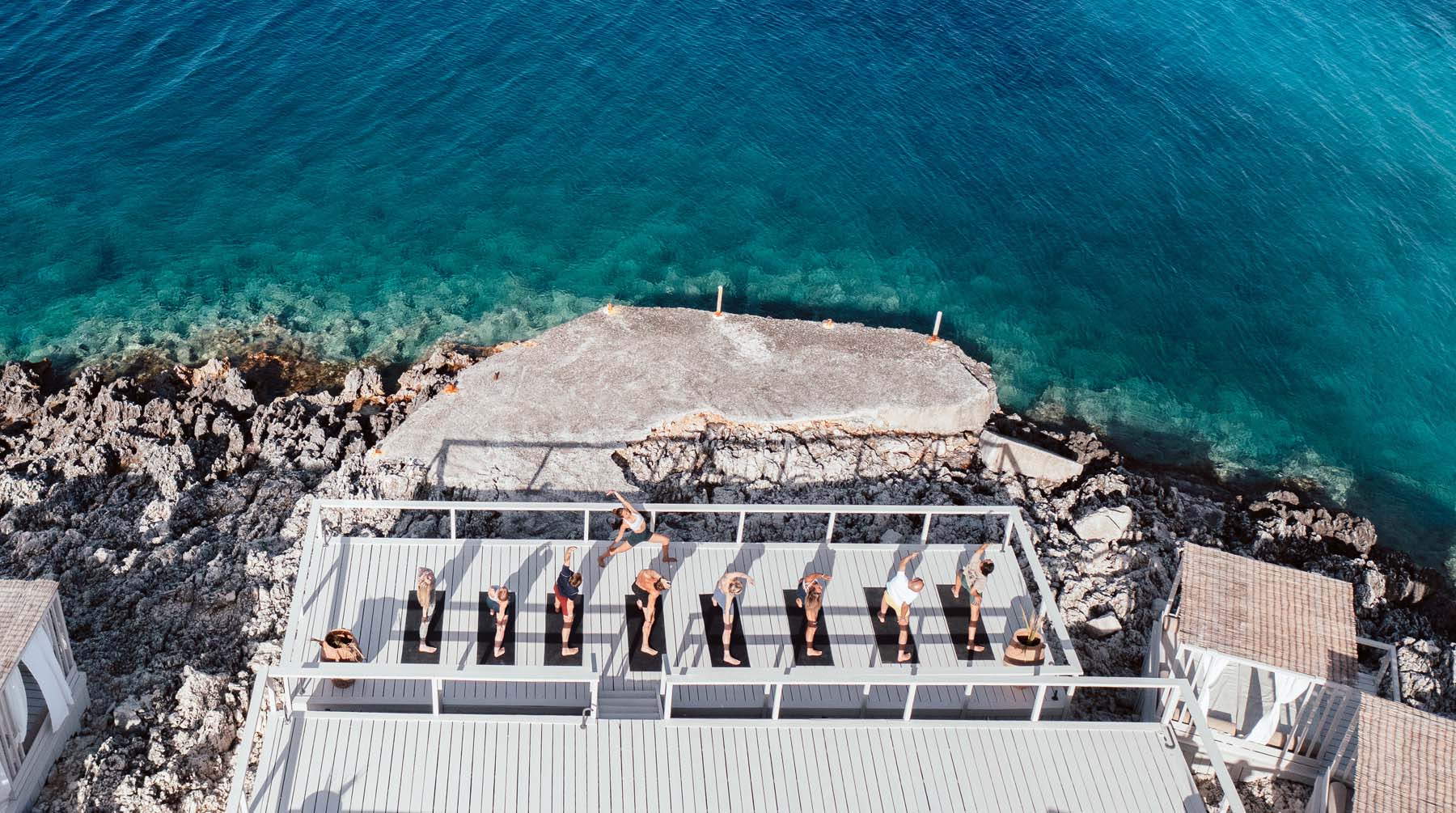 Group yoga on the decks by the sea