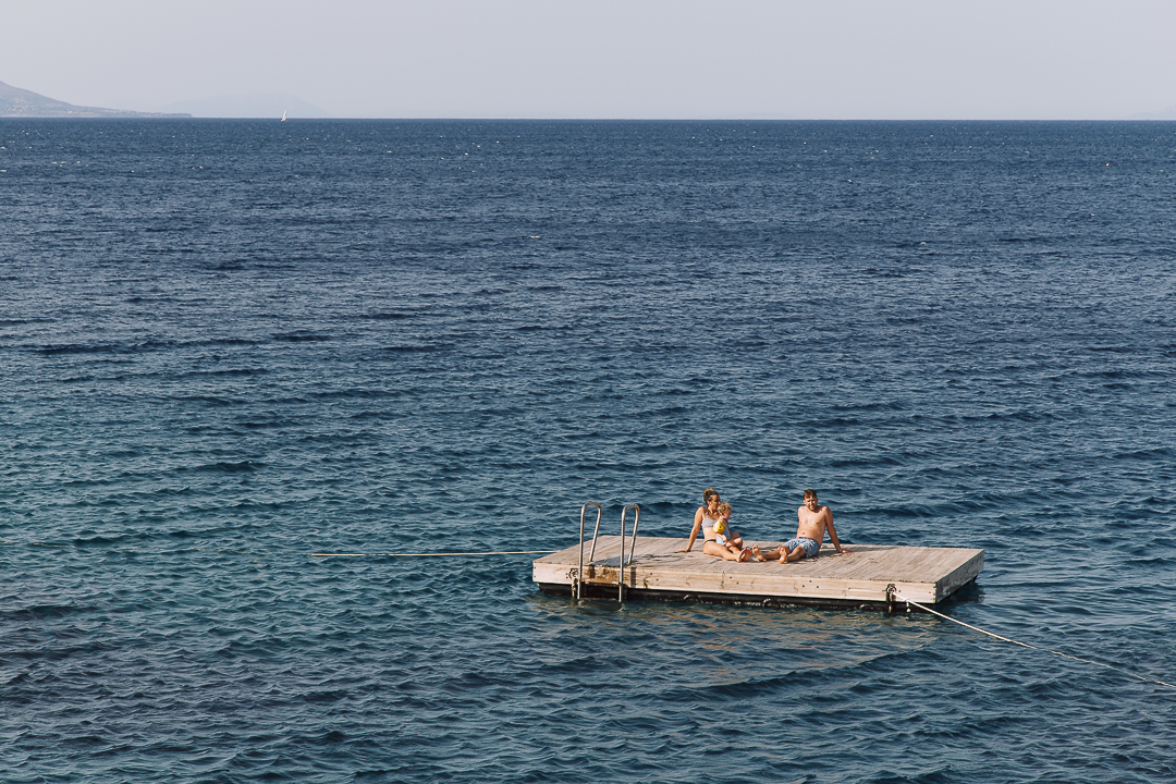 Couple relaxing on the pontoon at sea
