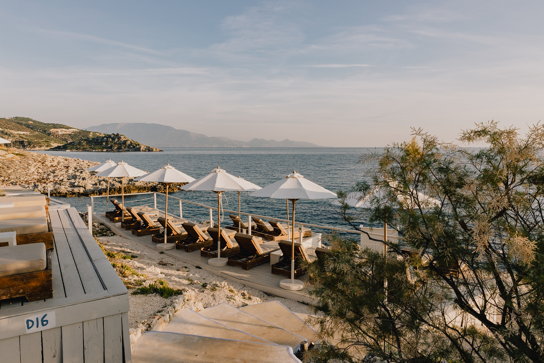 Luxurious wooden sun loungers overlooking the sea